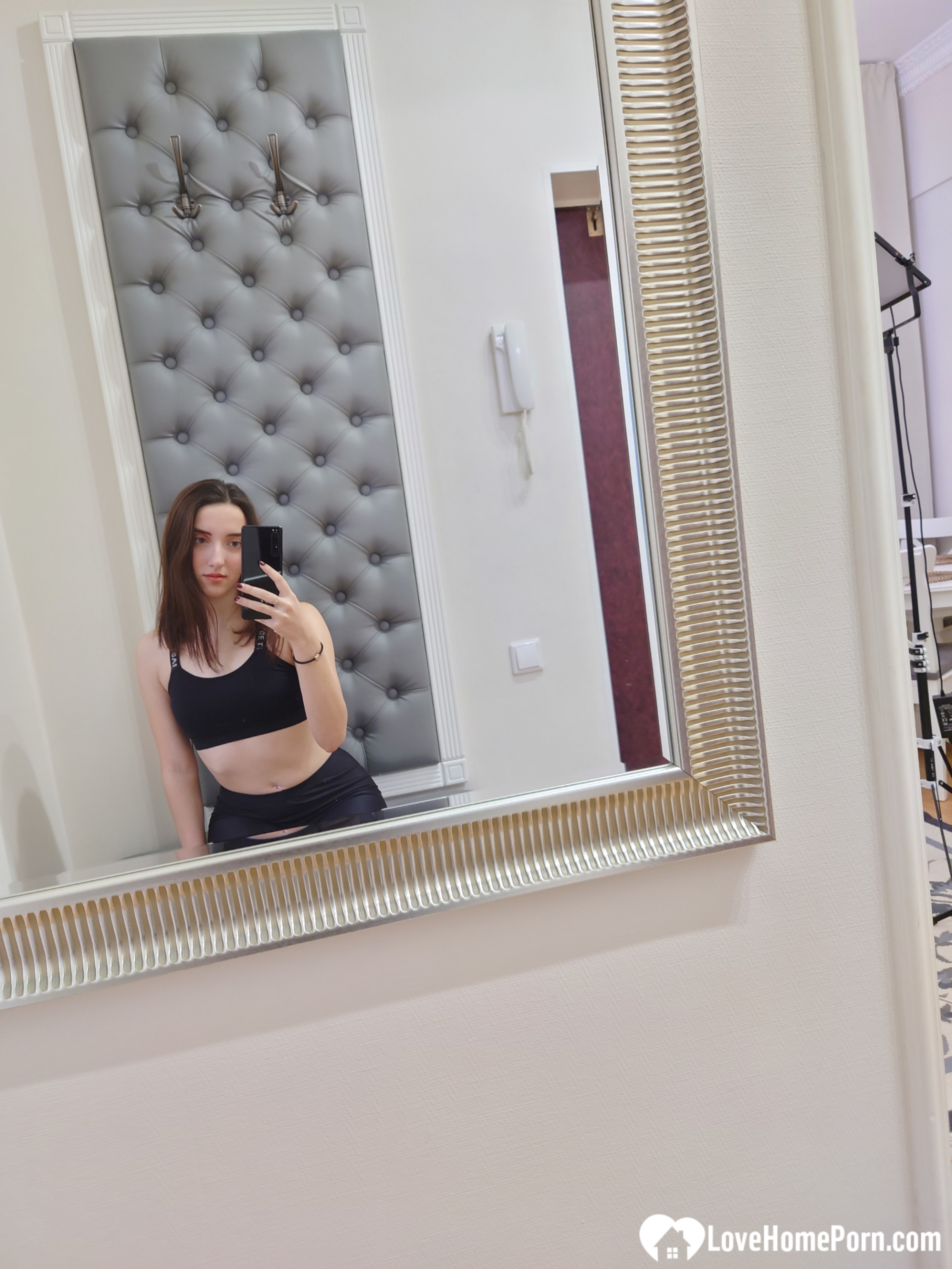 Cutie shows her stockings while posing passionately