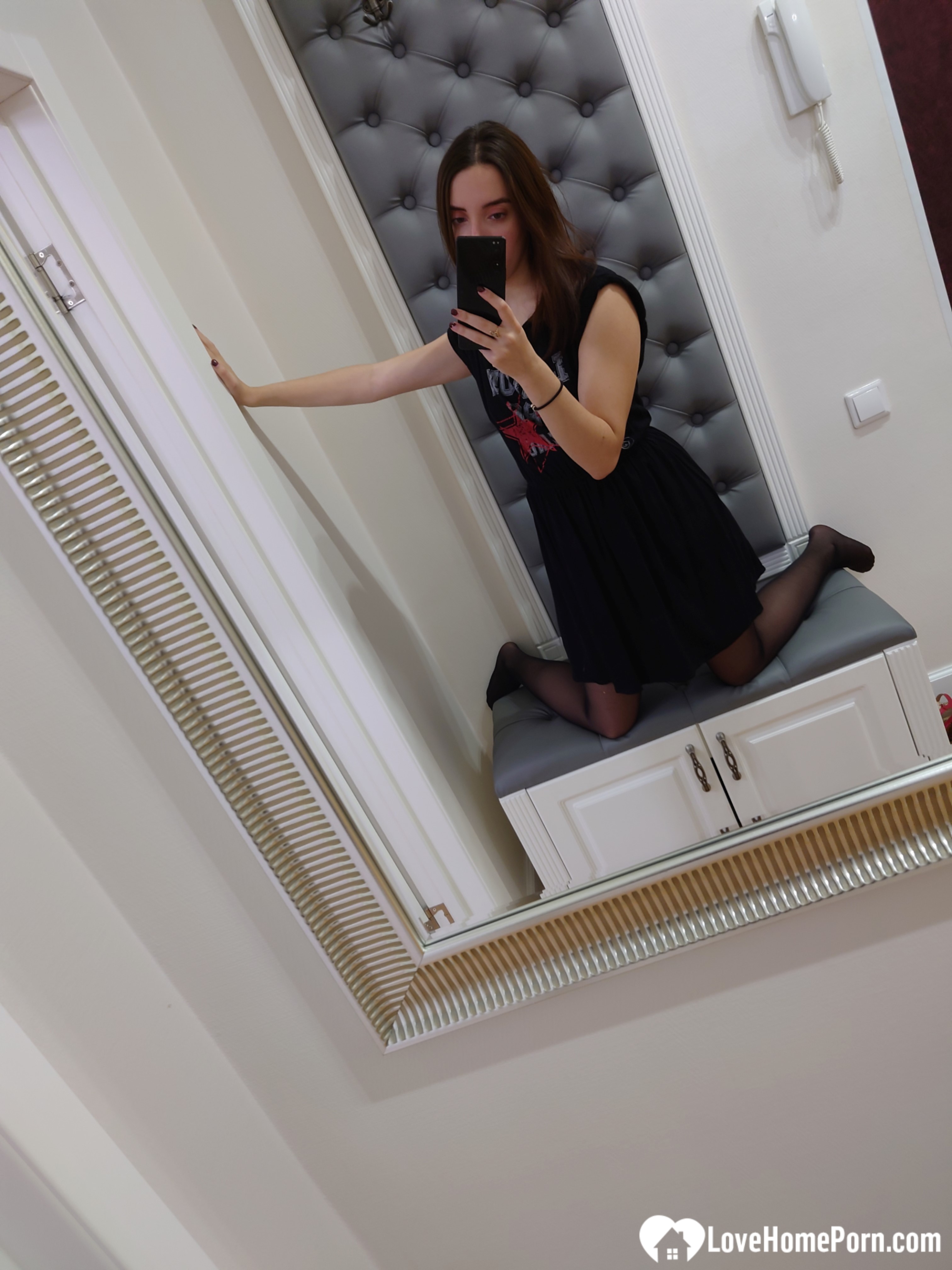 Cutie shows her stockings while posing passionately