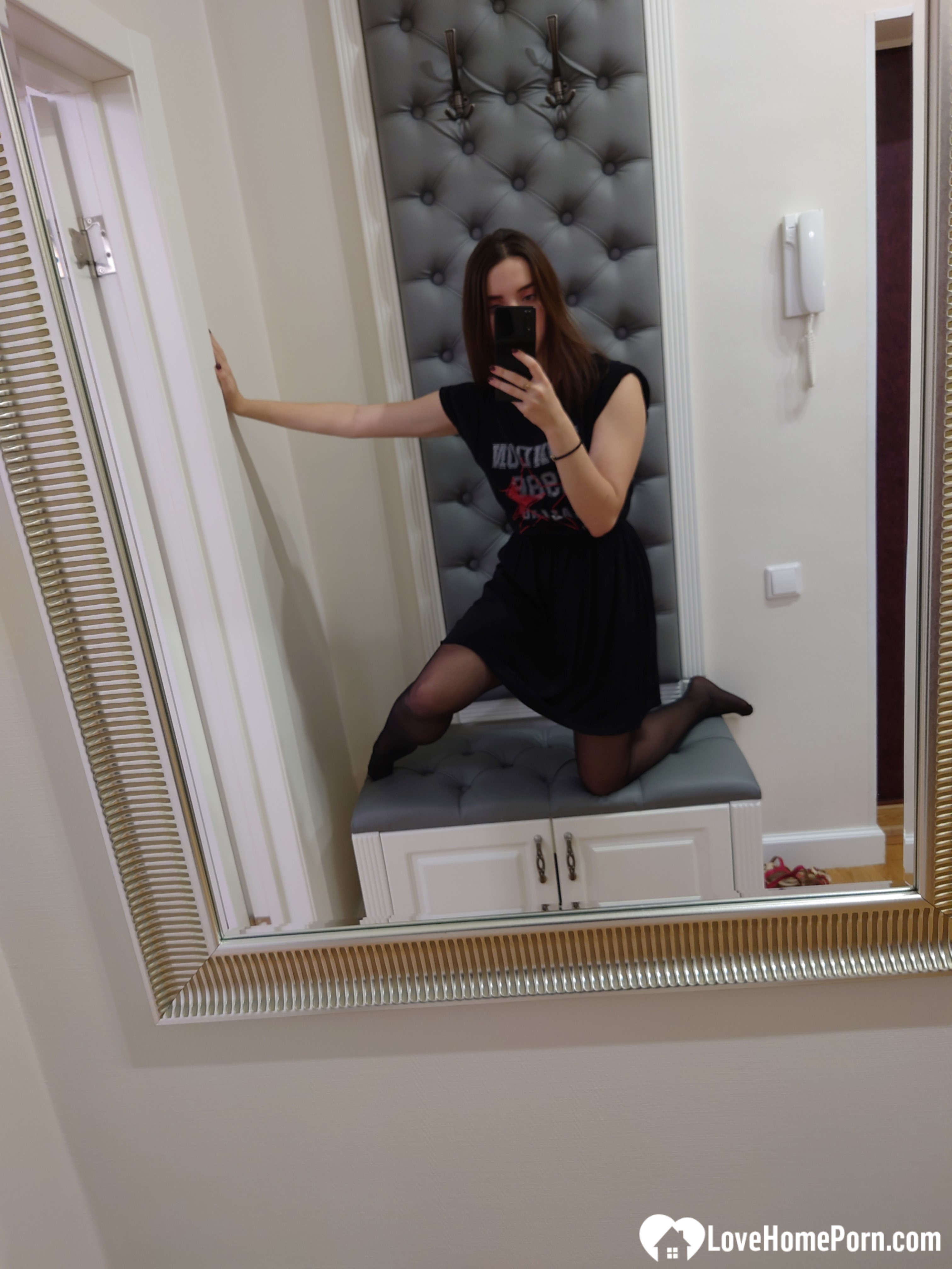 Cutie shows her stockings while posing passionately