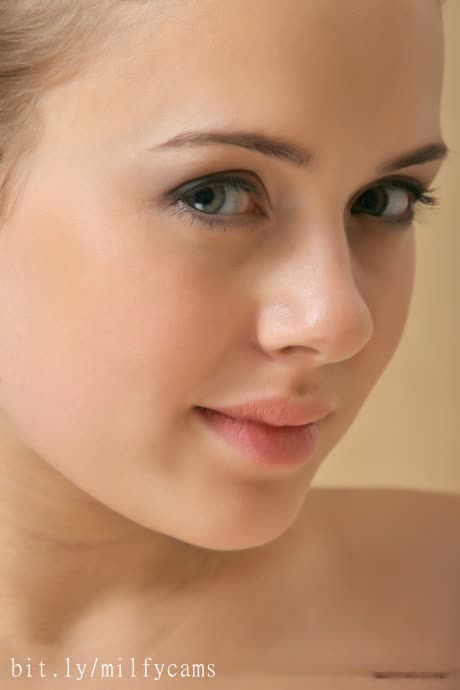 Leggy glamour babe Emily B displaying cute face and perky ti