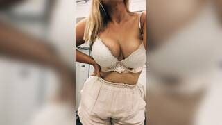 Blonde drops bra to reveal big tits
