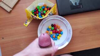 The student adds the most delicious sauce to his M&M's