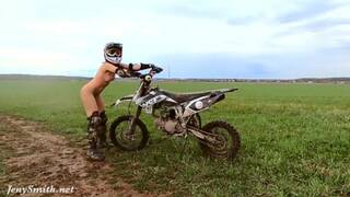 Naked woman riding a Dirt Bike