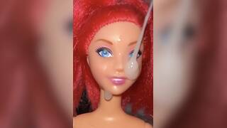 Fake Red Barbie facial cumshot close up