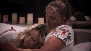 Charlie Forde and River Lynn on a grey coloured bed in several lesbian scenes