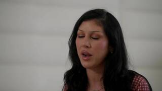 Queenie Sateen and Jane Wilde on a grey coloured bed in several lesbian scenes