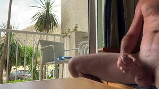 Man stroking cock in hotel