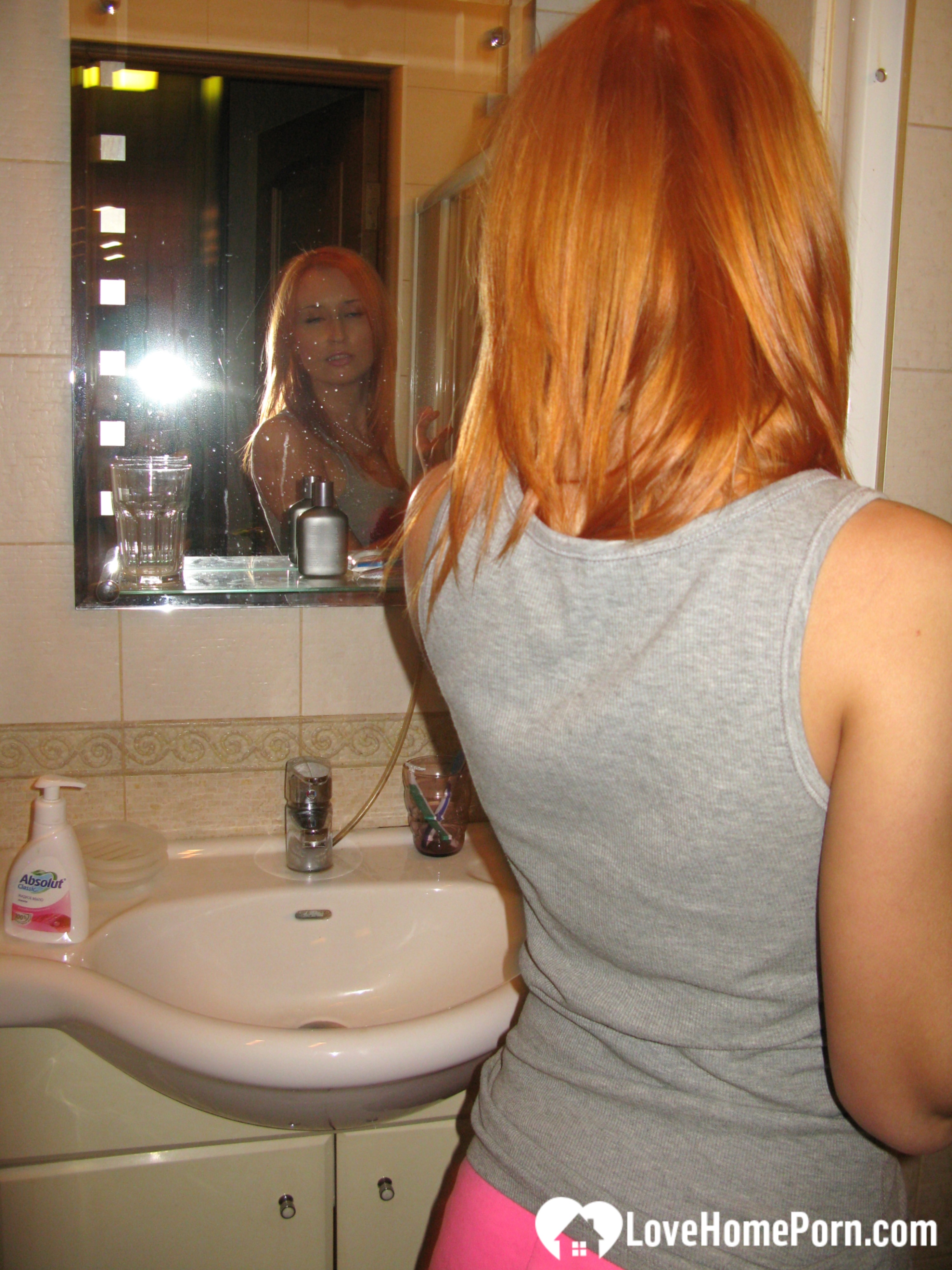 Redhead taking some hot selfies before showering