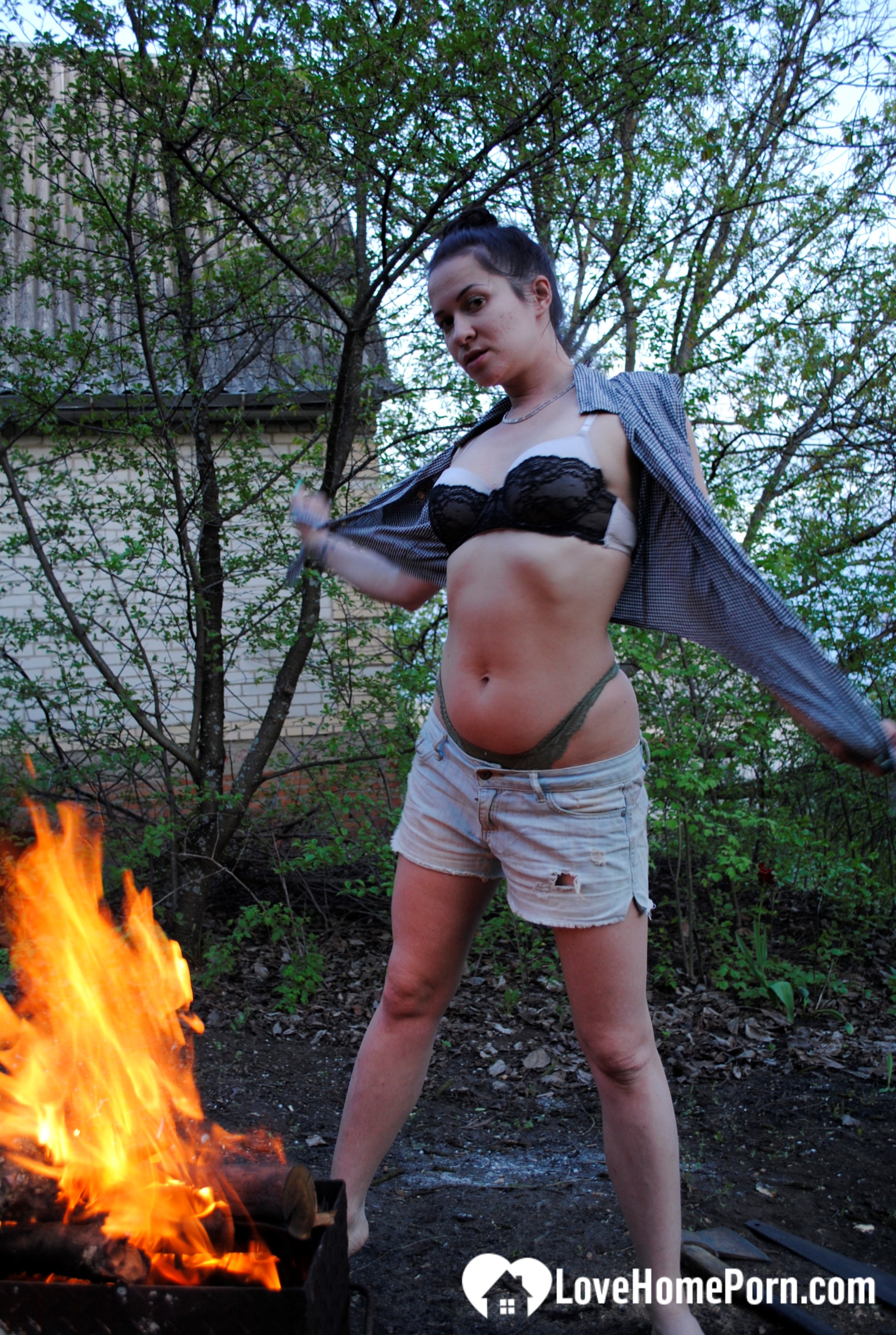 Barbecuing makes her hot so she strips