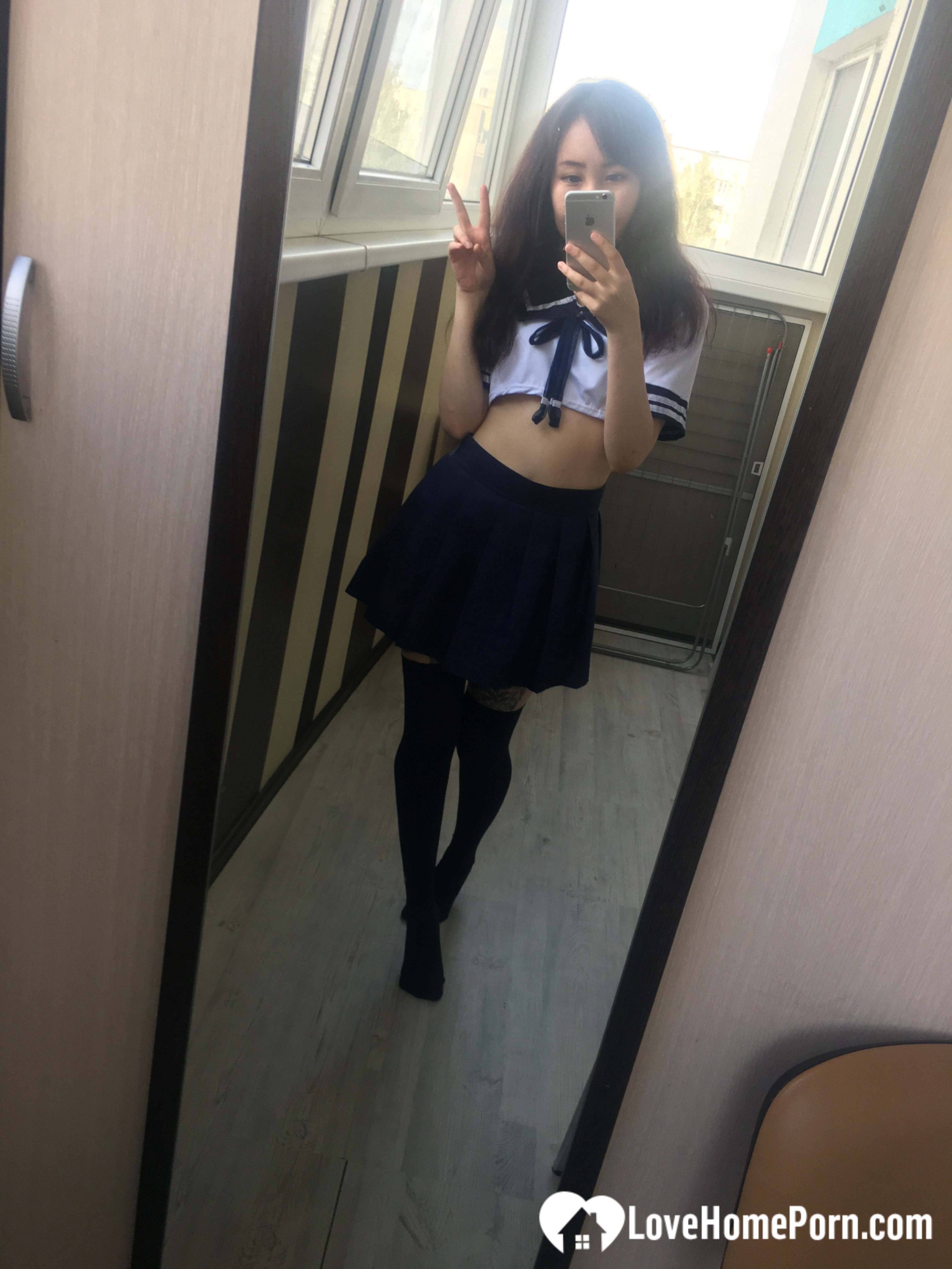 Asian schoolgirl flashing her pretty shaved pussy