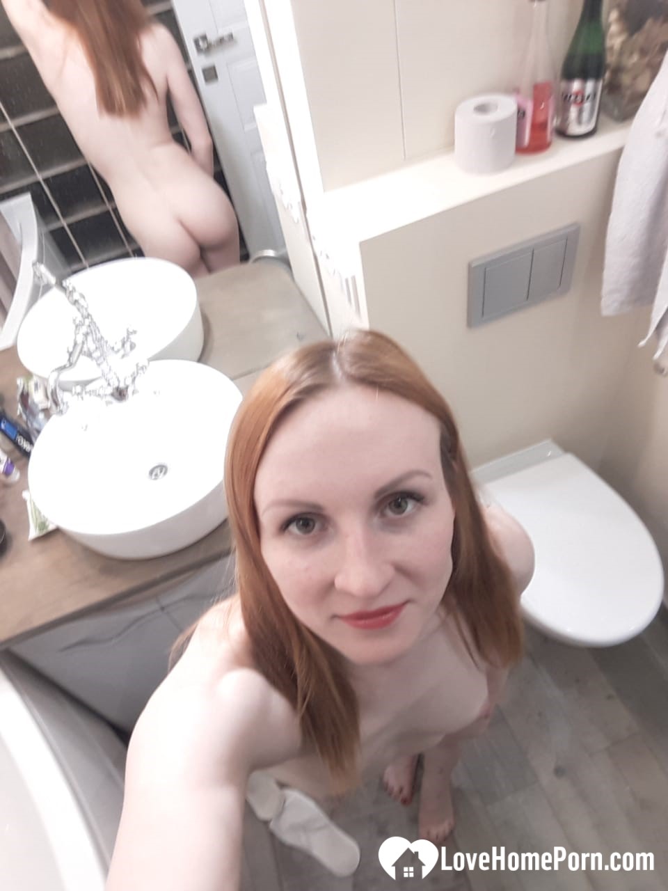 Skinny redhead with small tits in the mirror
