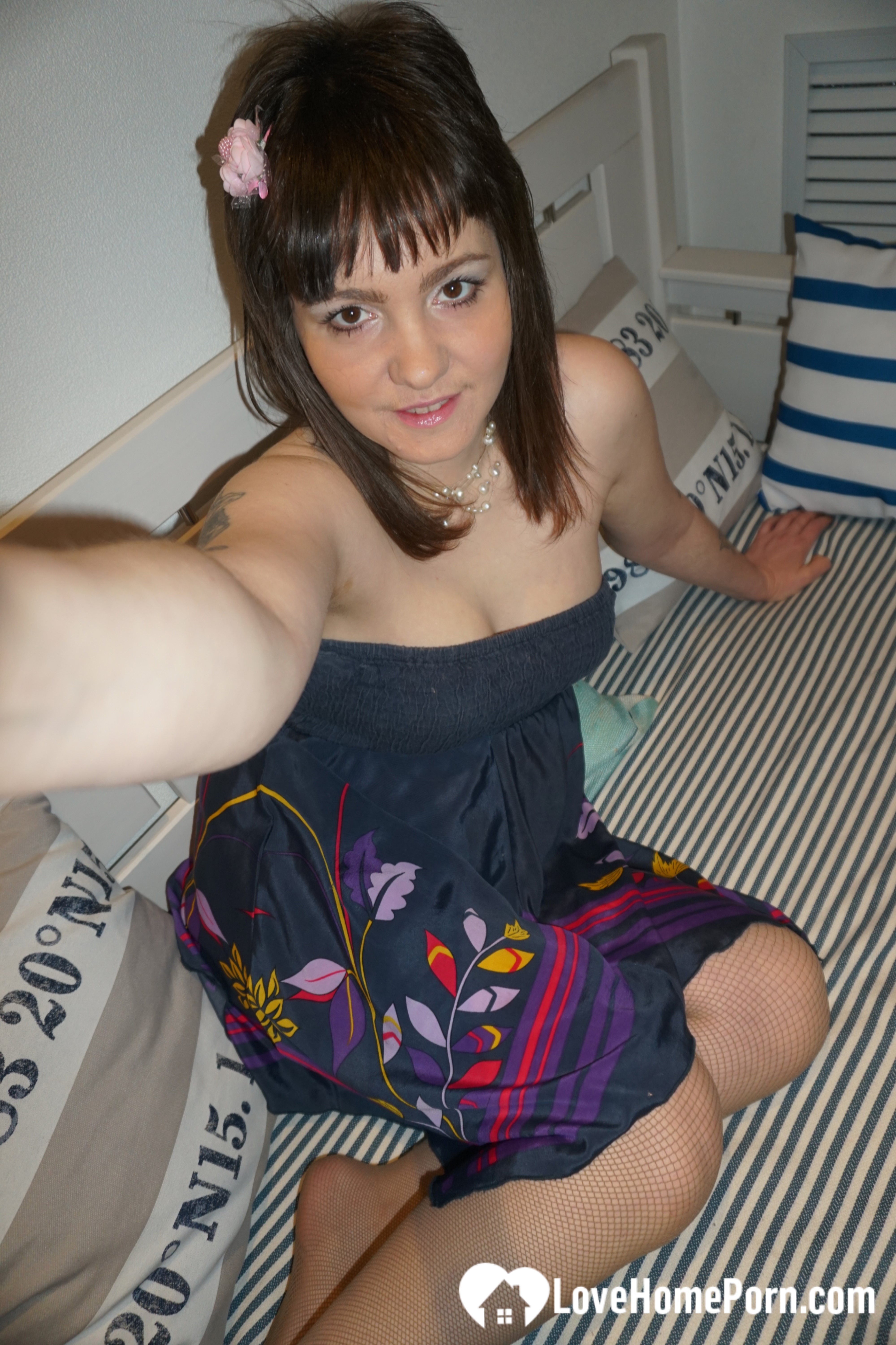 Brunette teen teasing in stockings in the bedroom