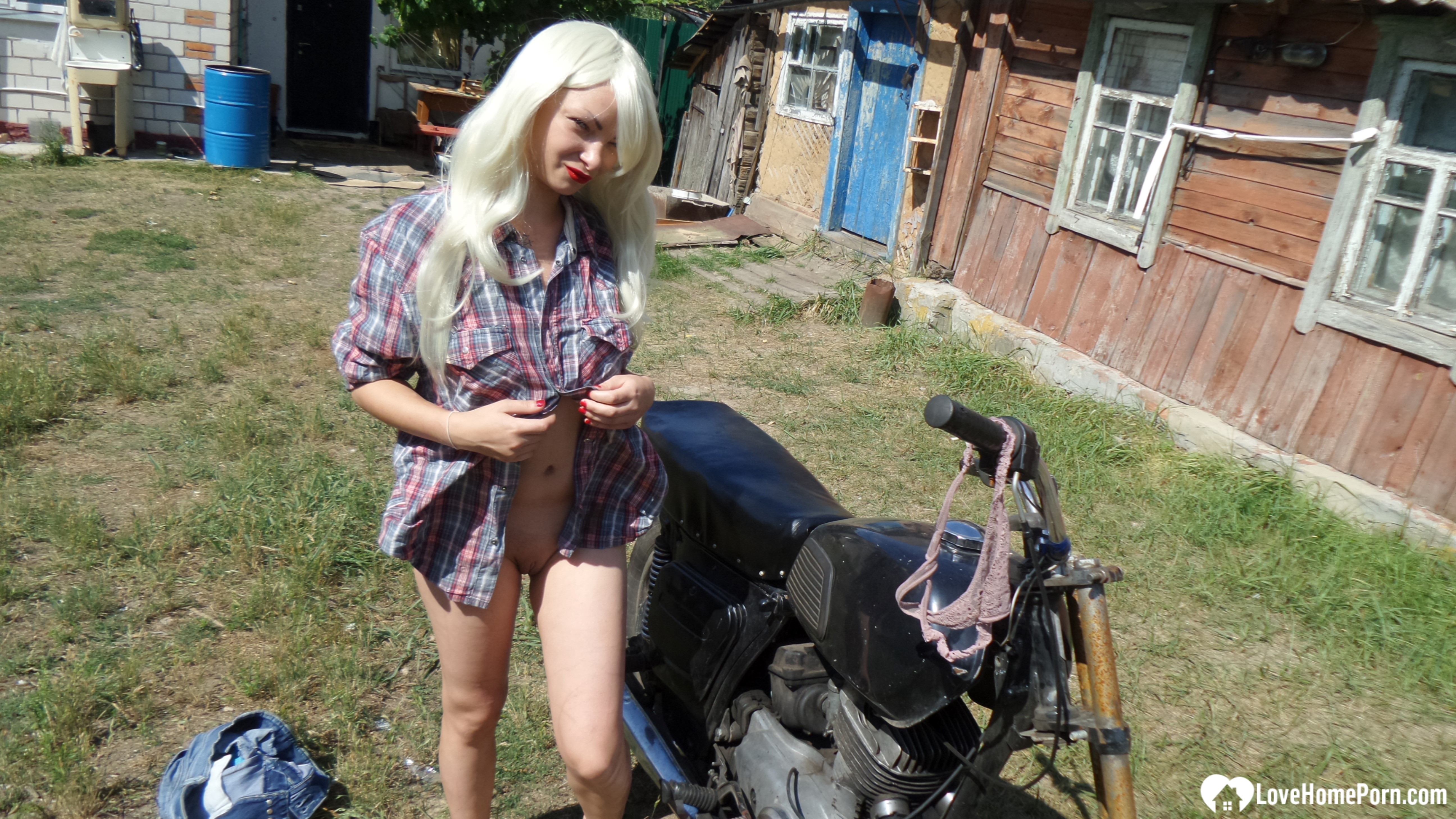 Blonde babe posing naked on a bike