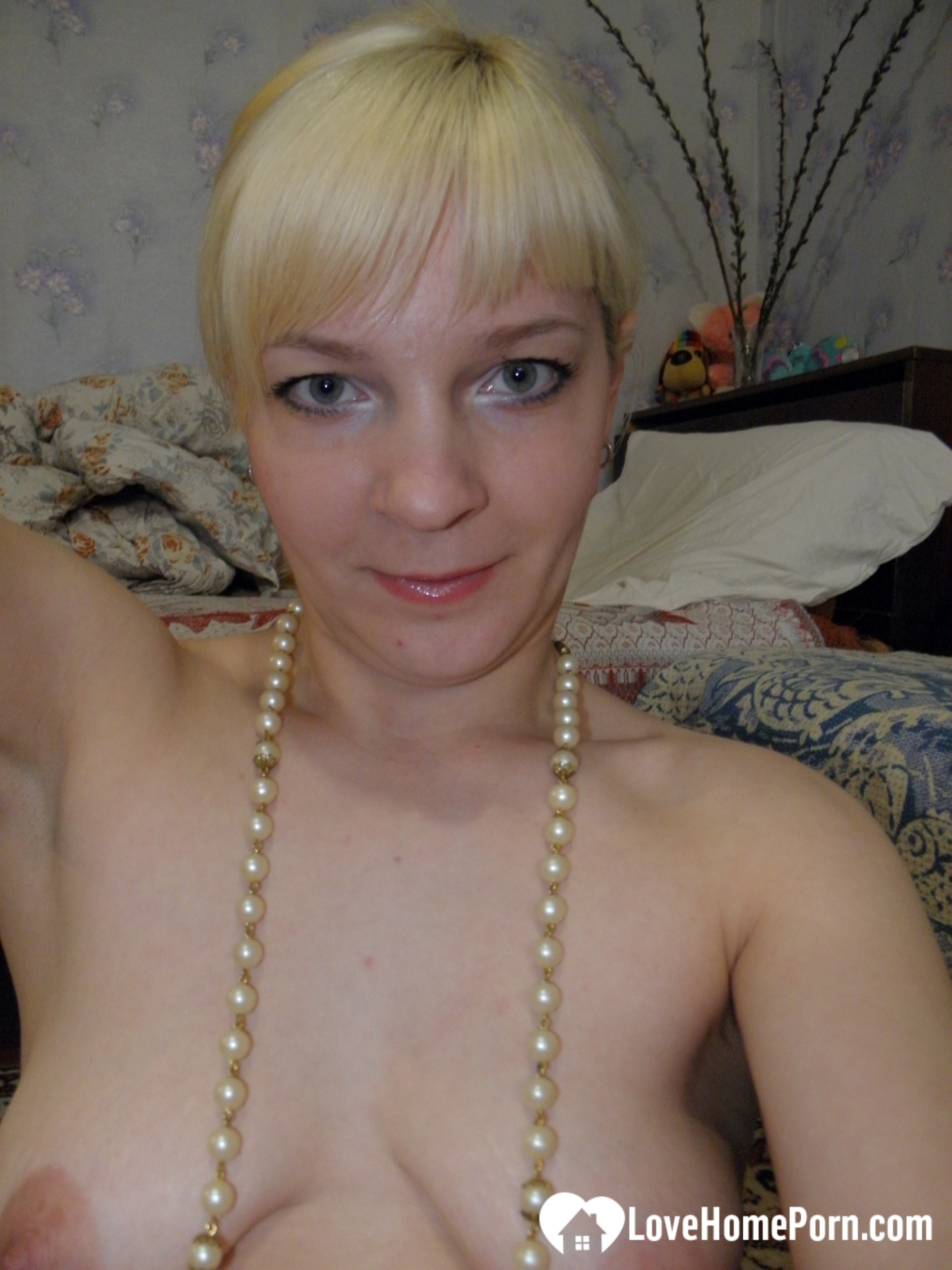 Aroused blonde in stockings taking naughty selfies