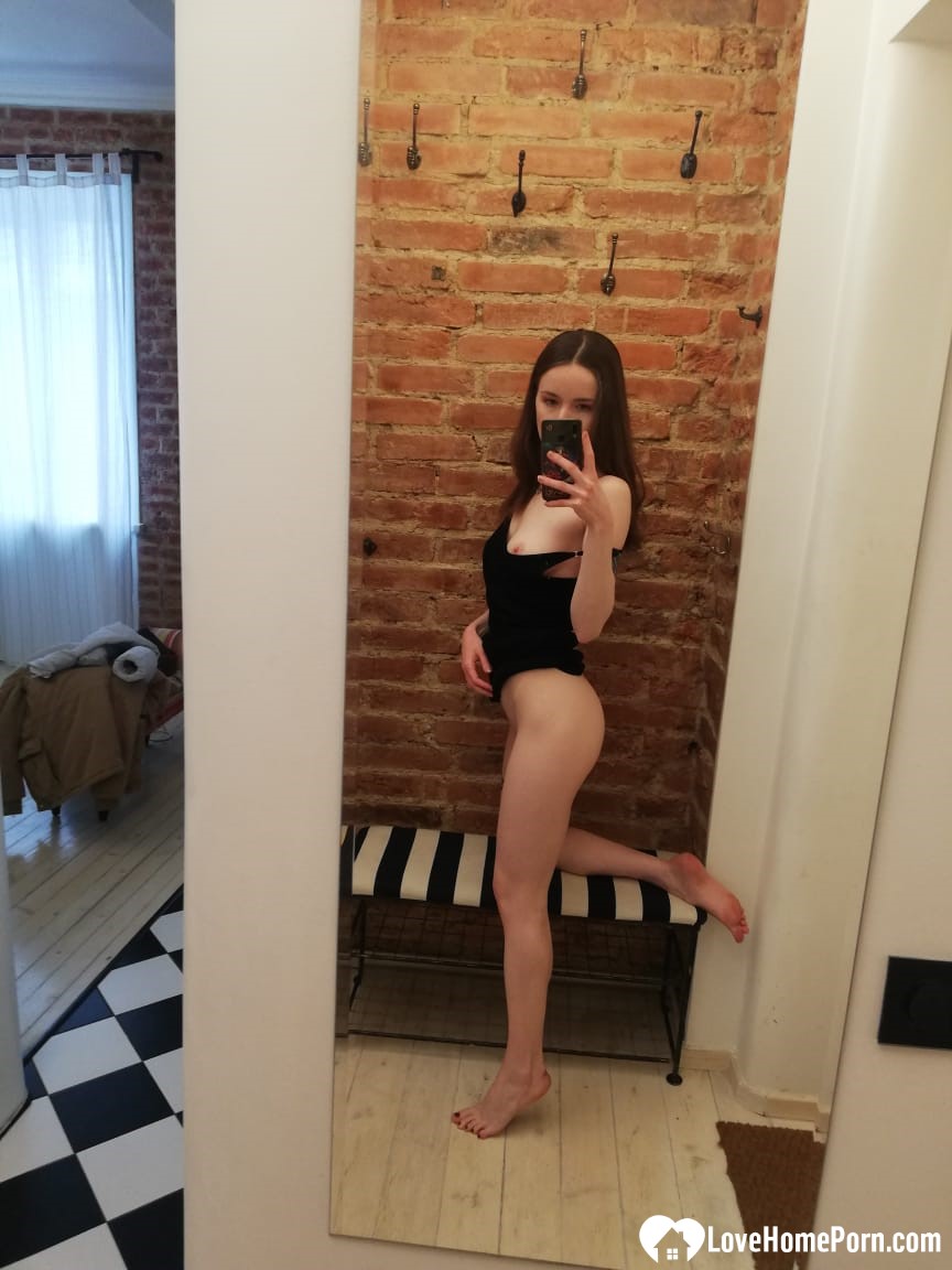 Skinny teen takes selfies in the mirror