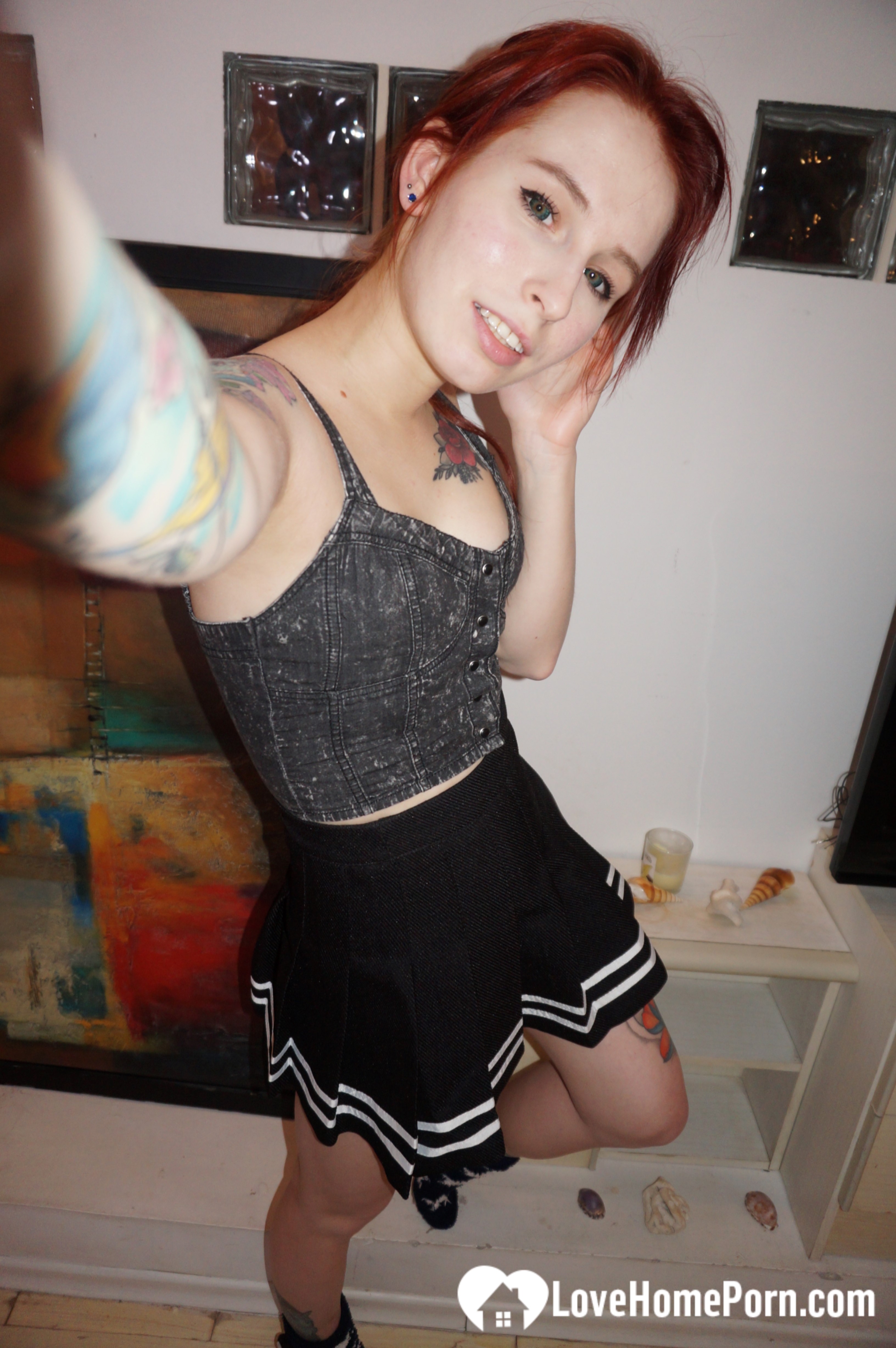 Desirable redhead painter showing off sexy outfits