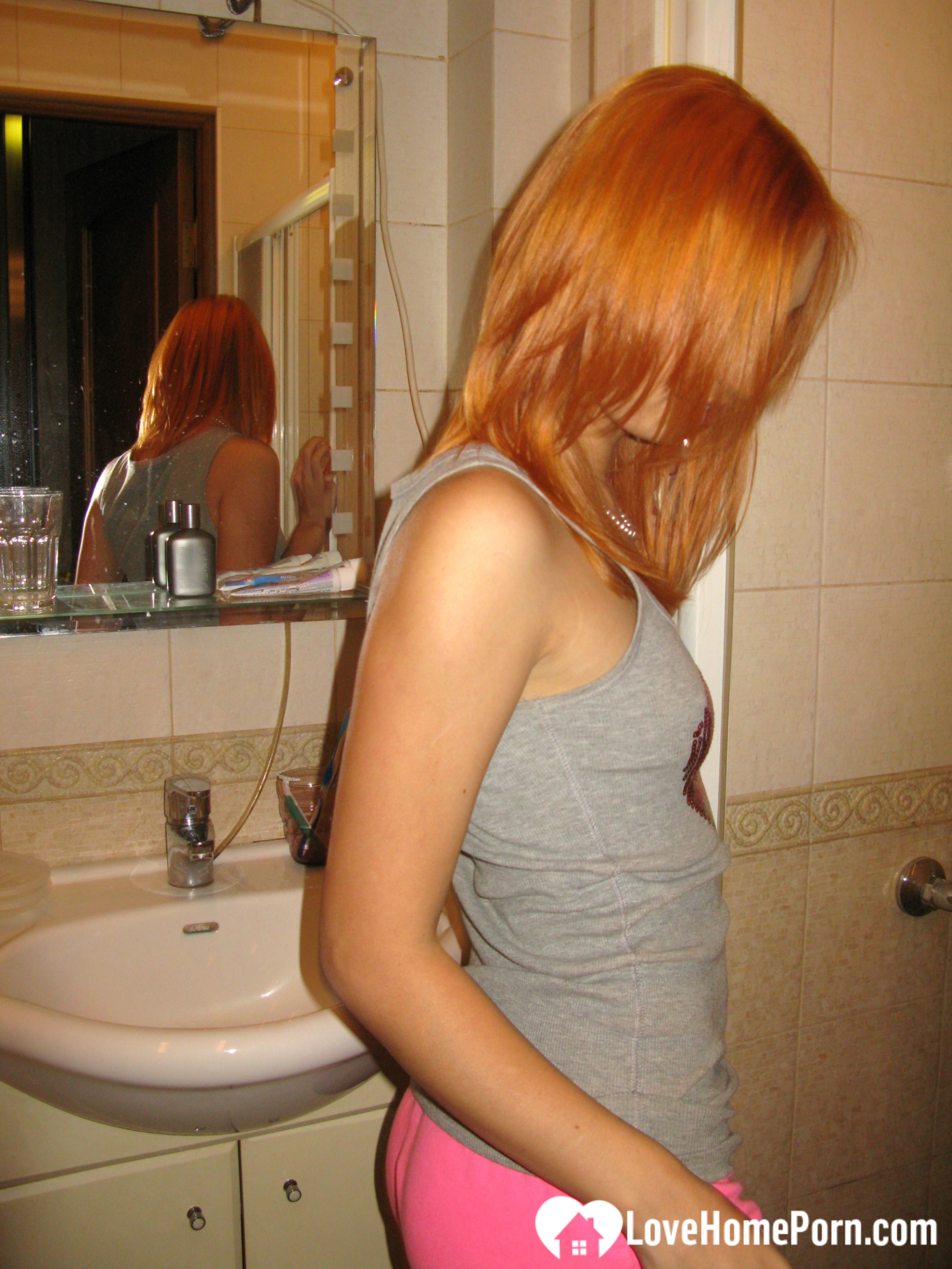 Redhead taking some hot selfies before showering