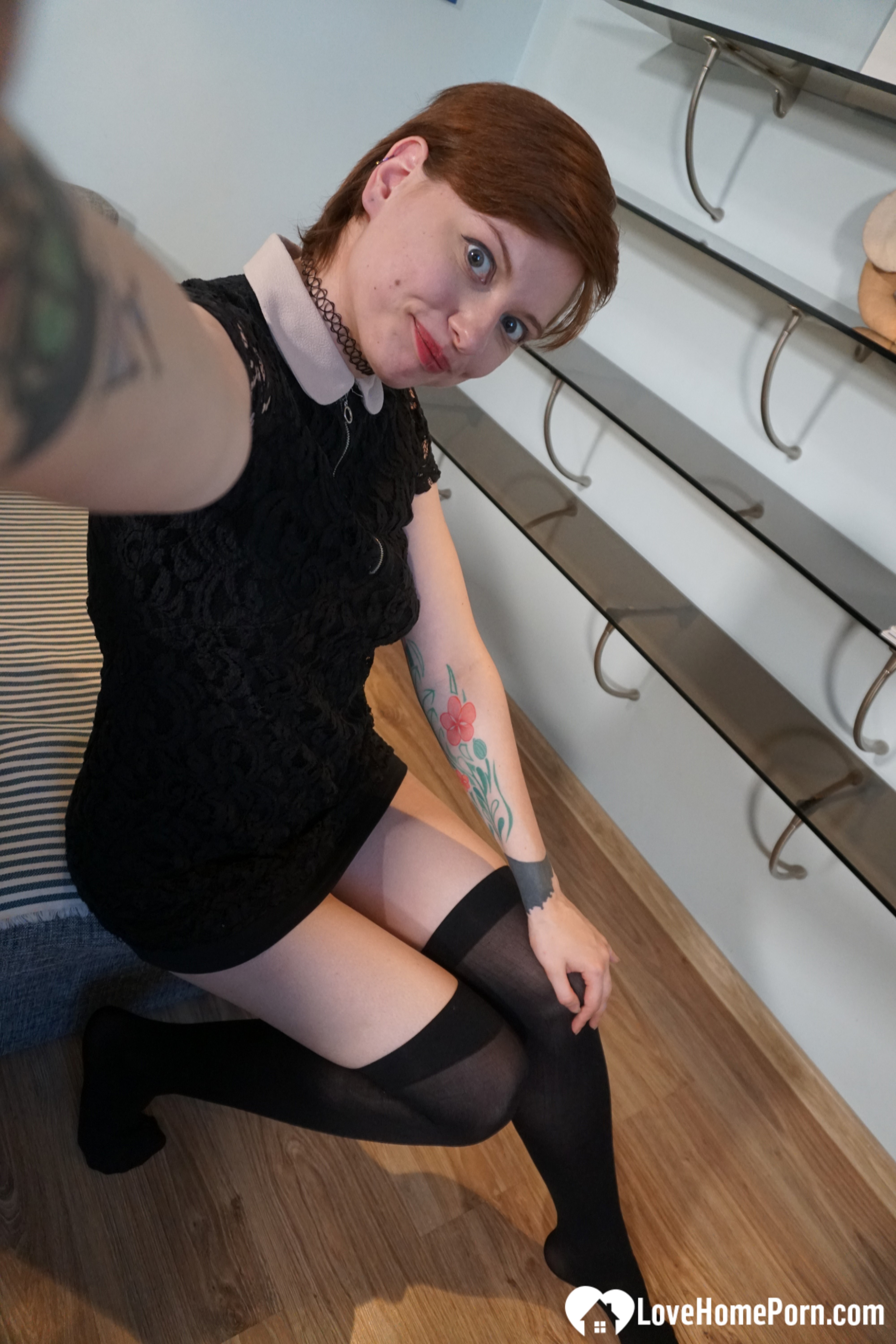 Sweet redhead gets naked in the office