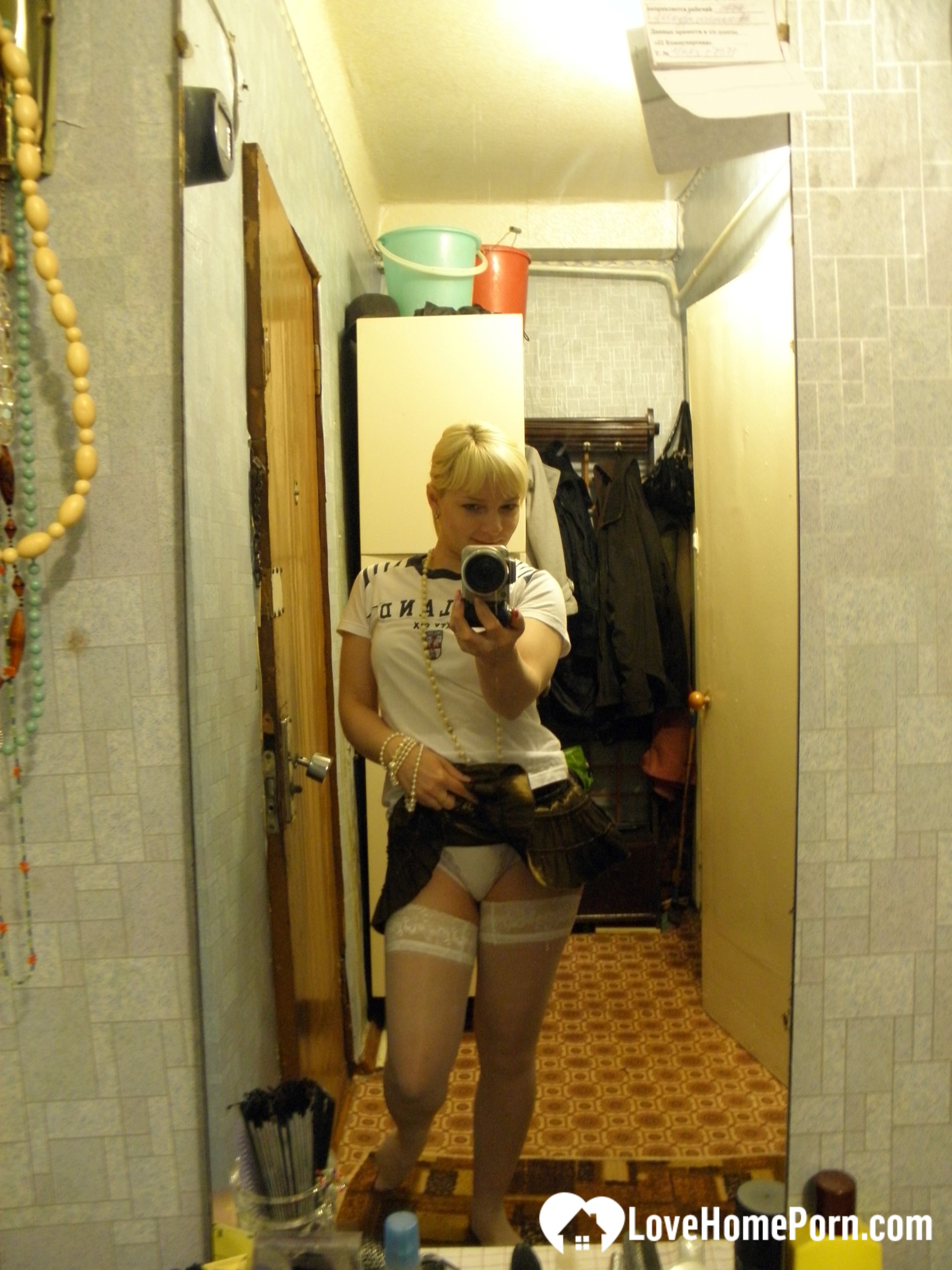 Aroused blonde in stockings taking naughty selfies