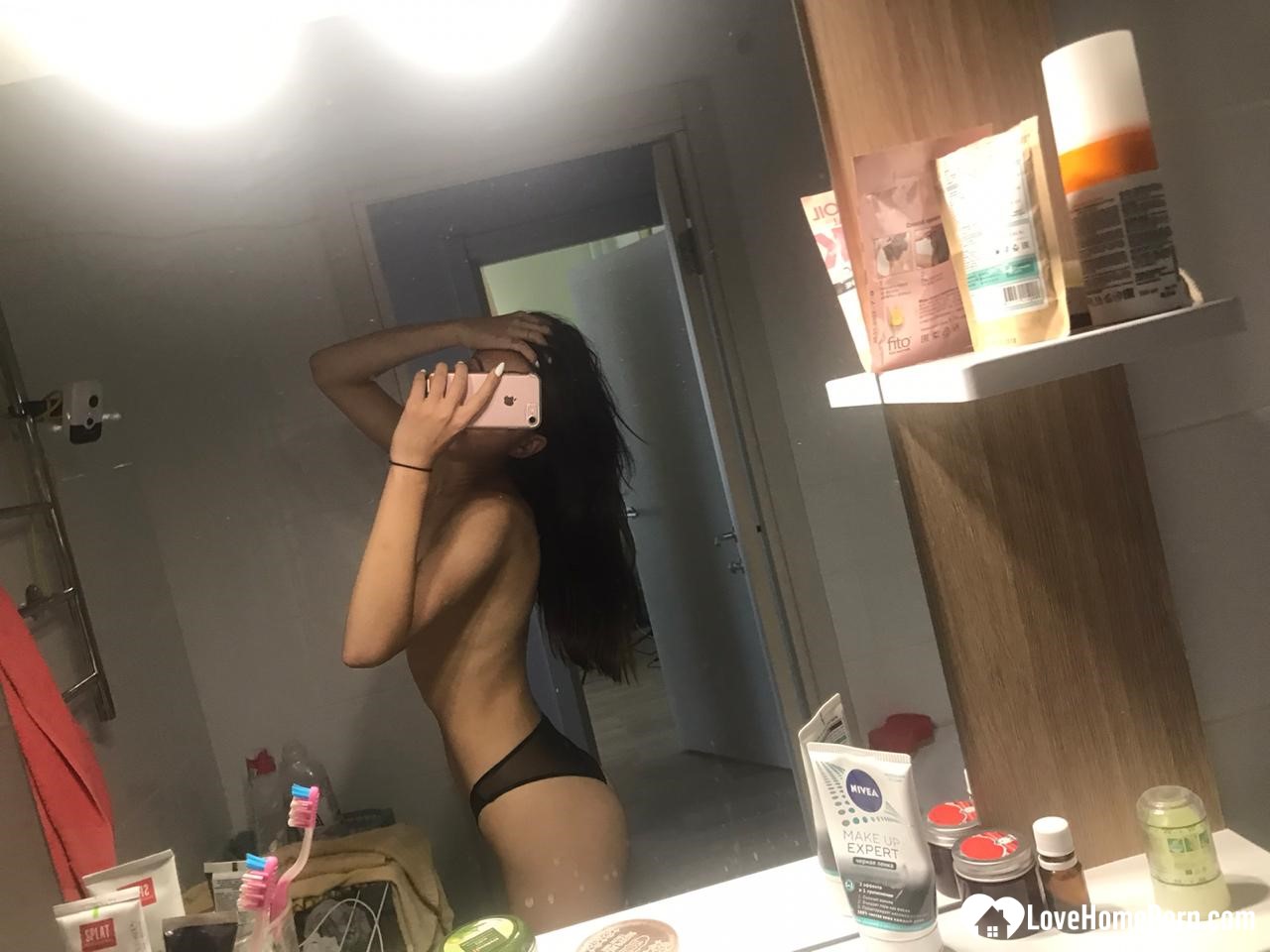 Hot schoolgirl reveals her tits in the mirror